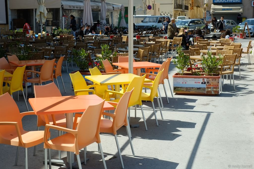 seats and tables outside cafés in Birżebbuġa
