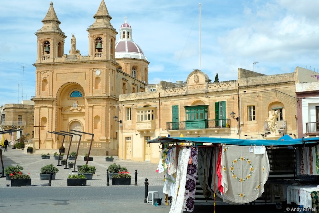Marsaxlokk Parish Church, with a market stall in the foreground