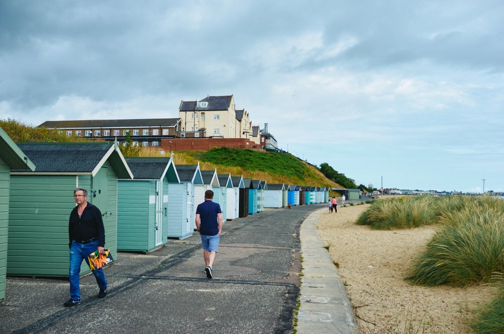 beach huts and walkers