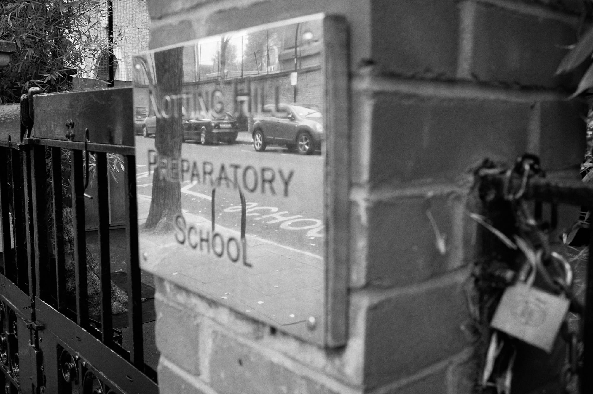 reflection in gate sign for Notting Hill Preparatory School