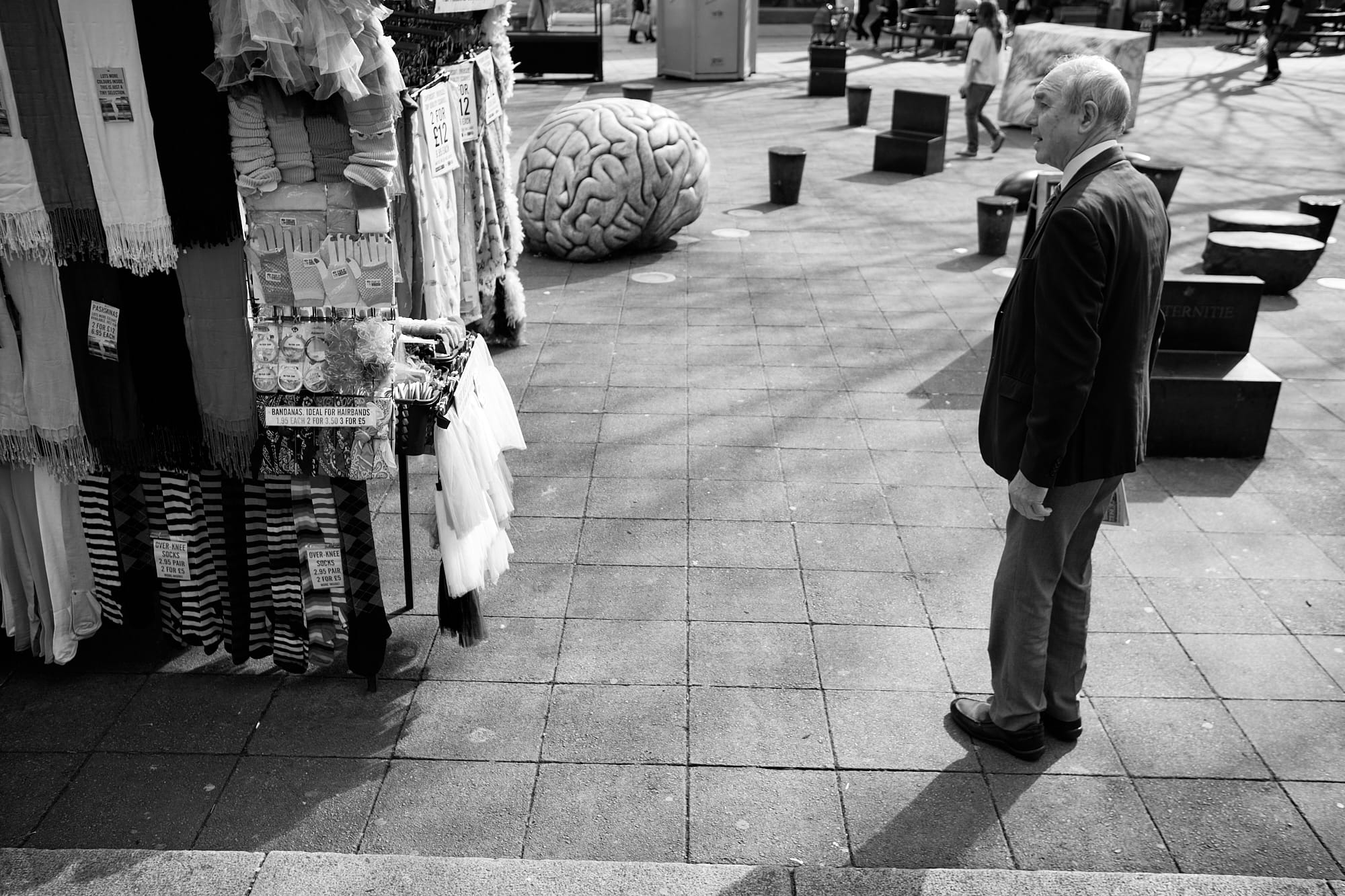 old man looking at market stall