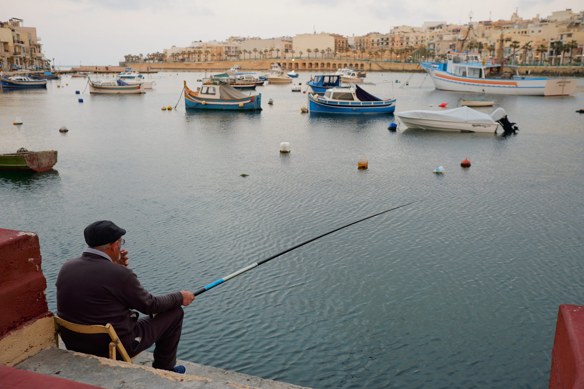 man fishing in Marsaskala bay