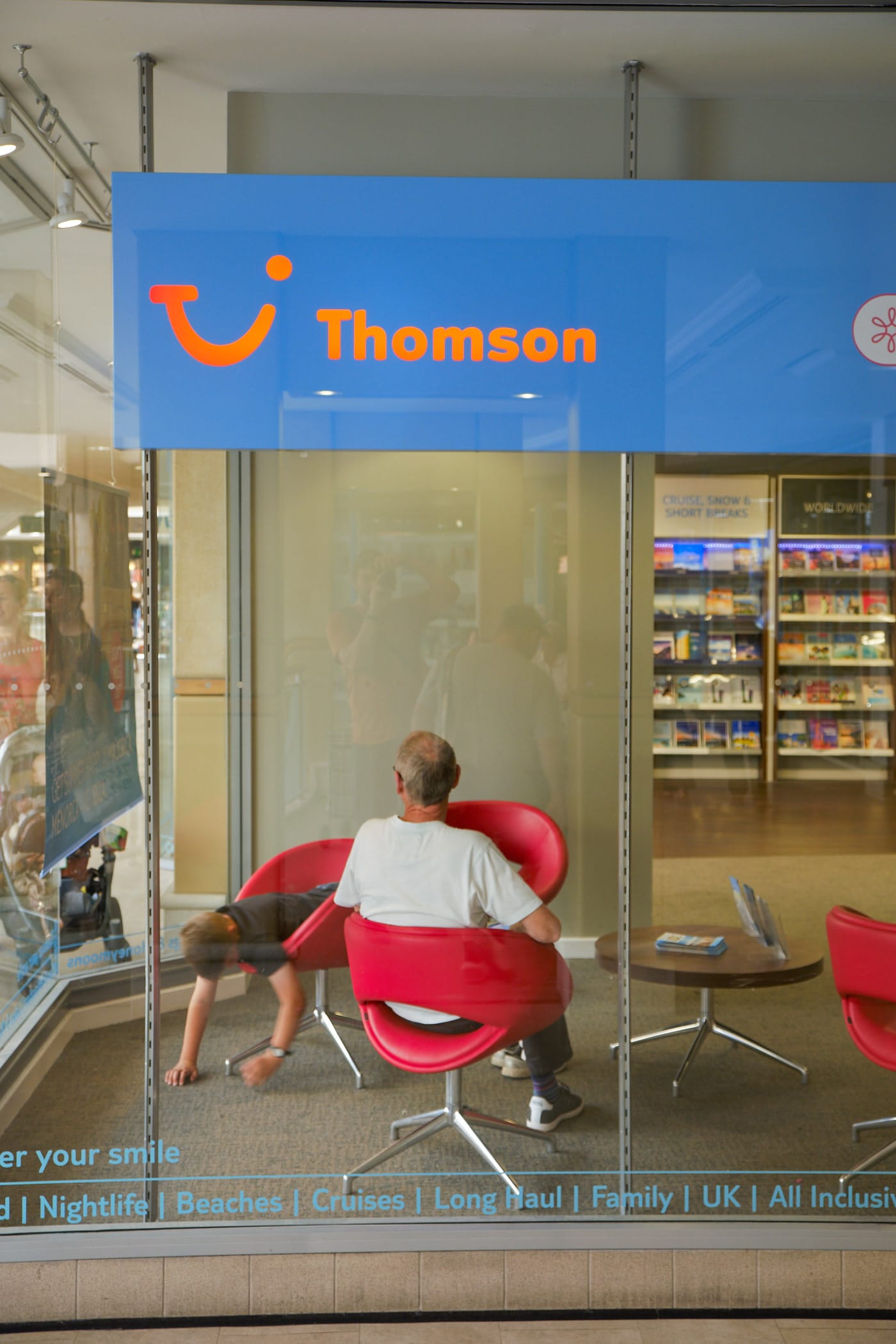 man and boy in Thomson travel agents