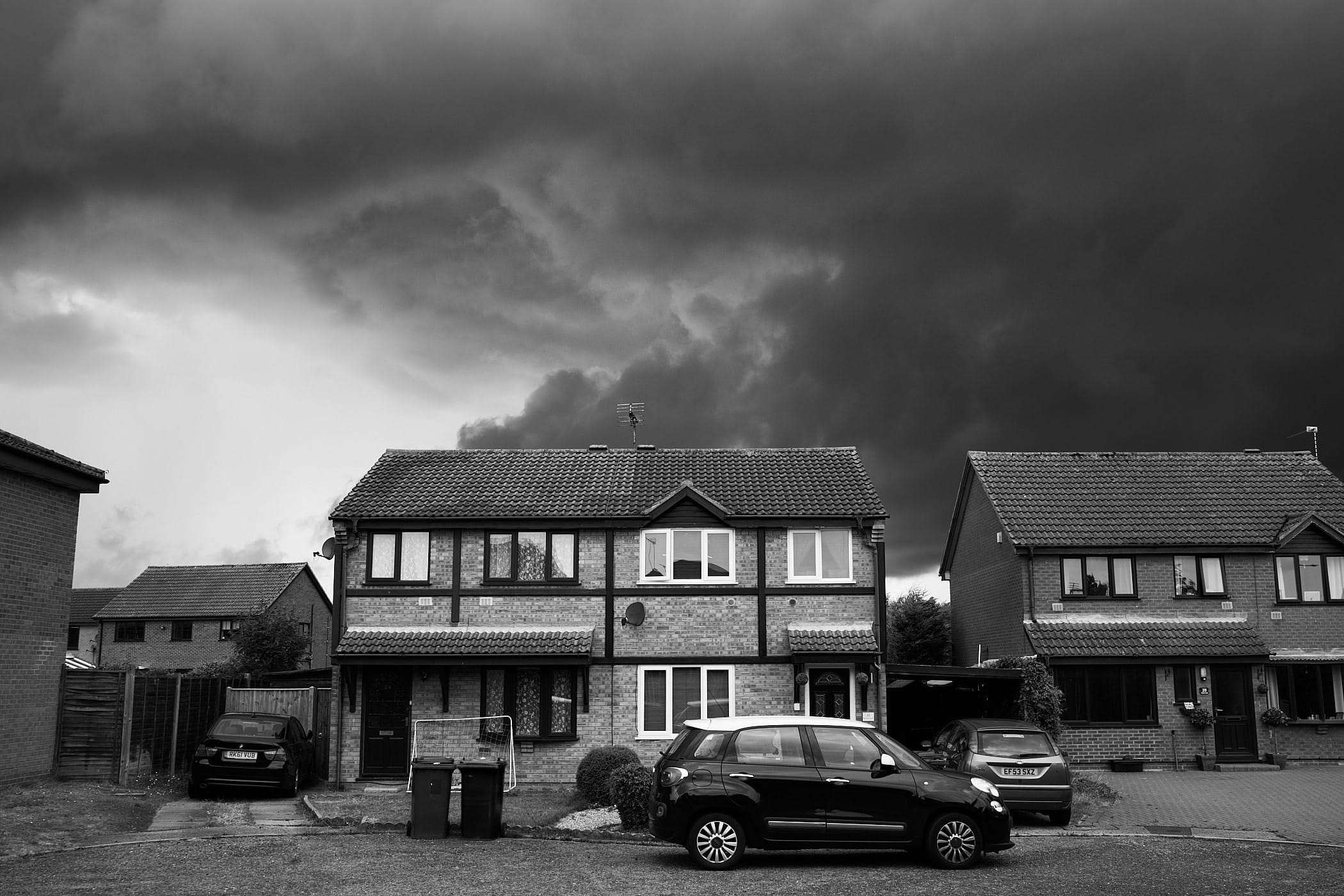 brewing storm behind houses