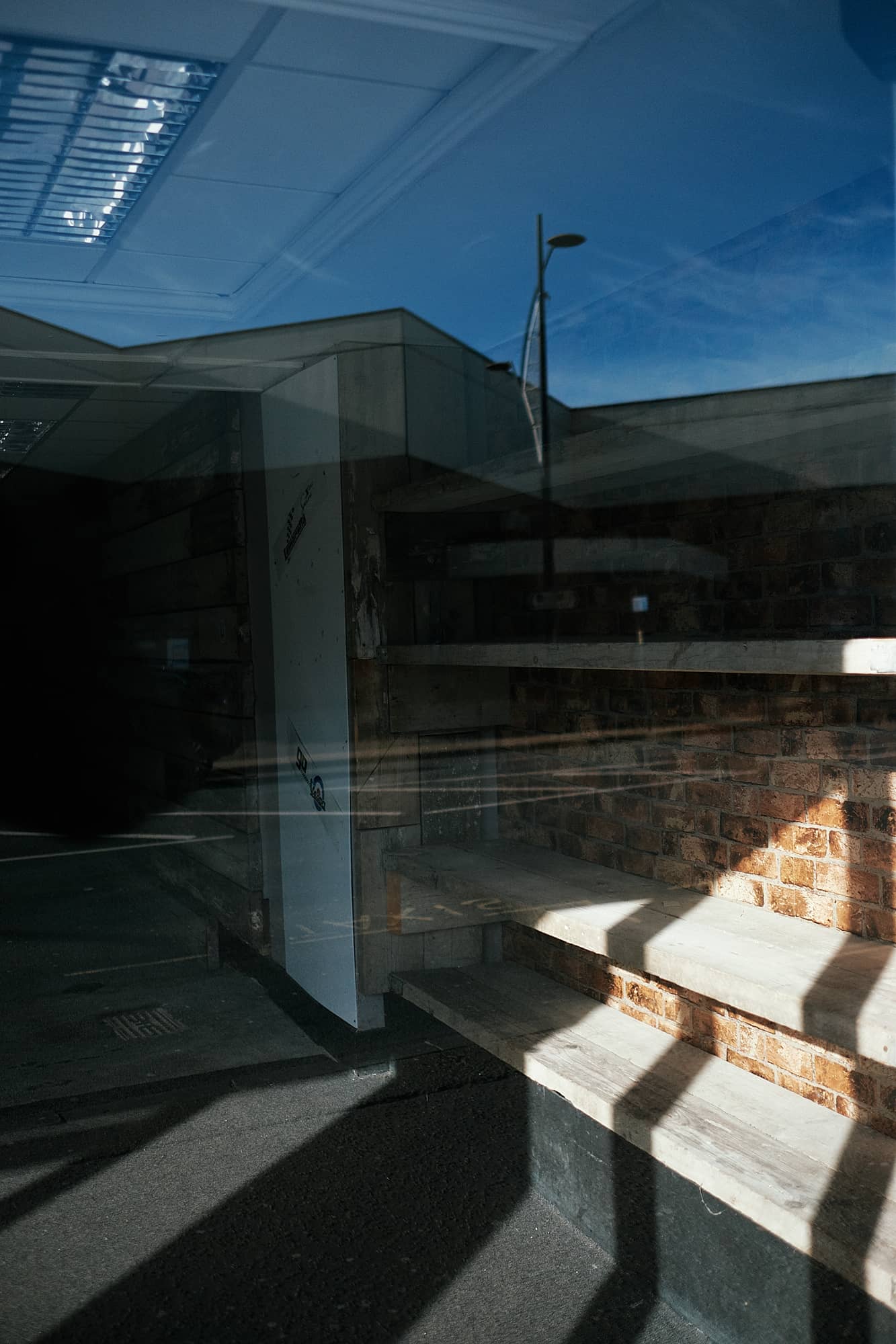 reflections and shadows in an empty shop building