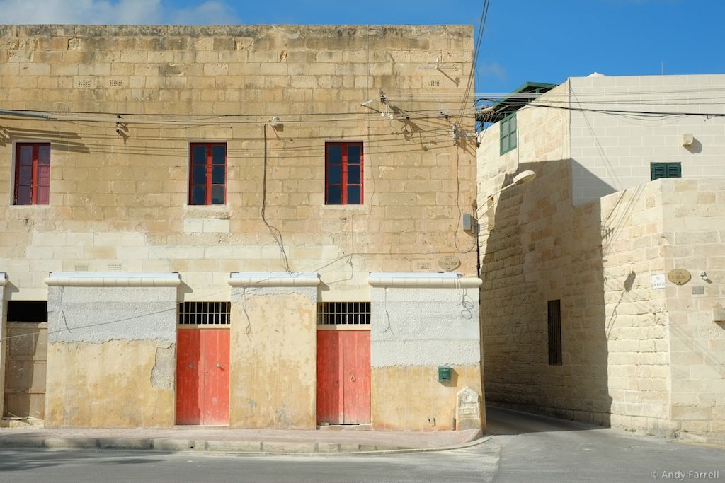 red doors in yellow building