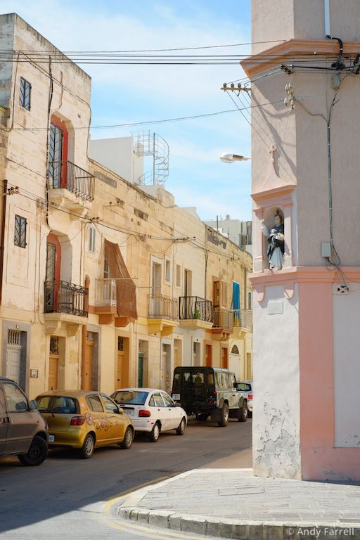 small statue in an alcove on a street corner