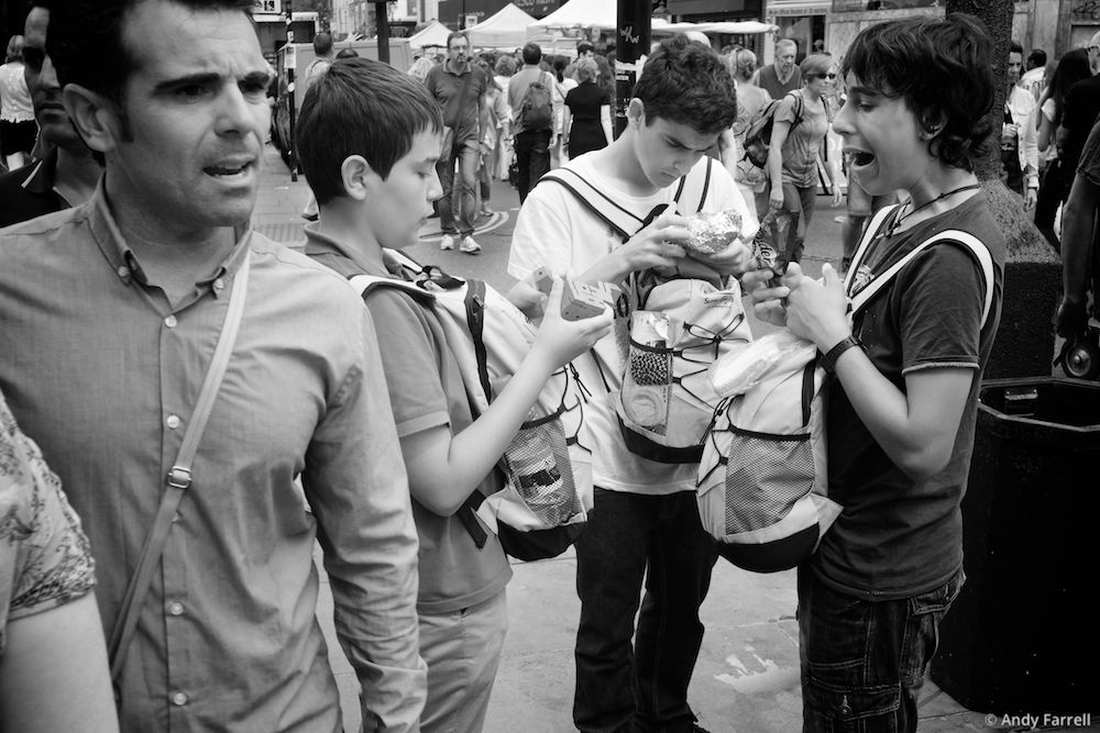 three boys with backpacks on their fronts