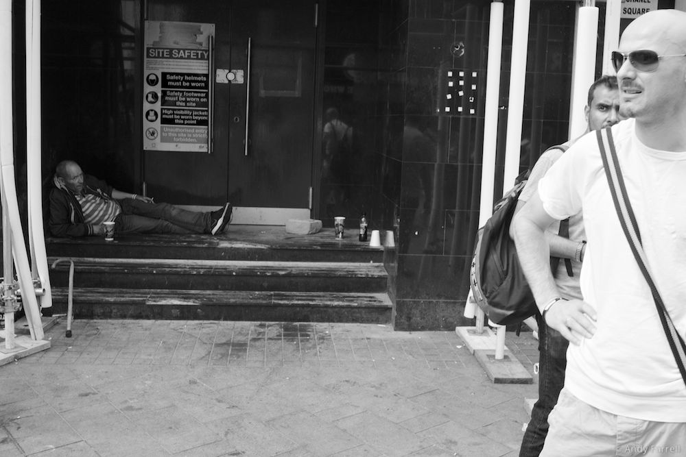 man resting in a doorway