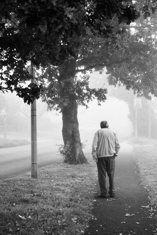 man waiting at bus stop