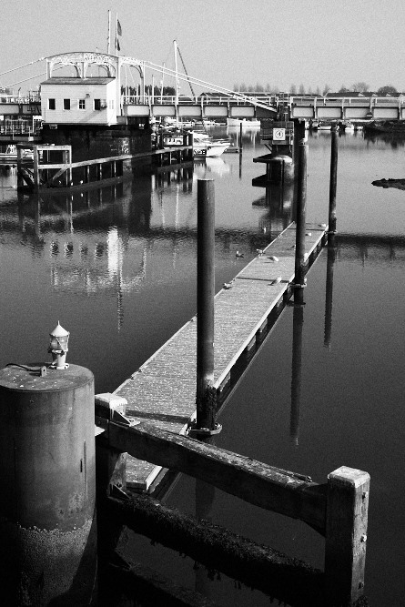 a jetty leading towards the rail bridge