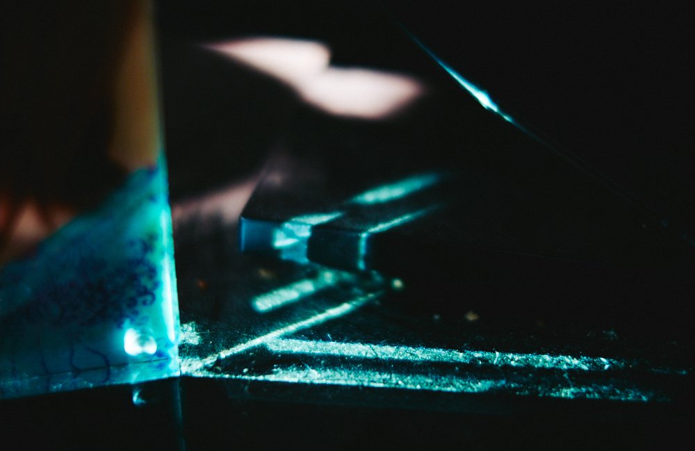 cyan refractions through a glass photo frame