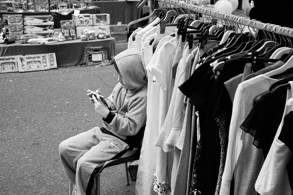 market boy on his phone