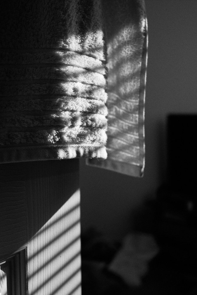 window blind shadows on towel and door