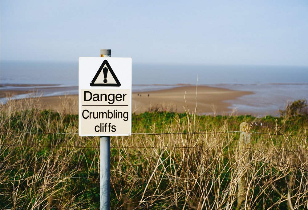crumbling cliffs warning sign