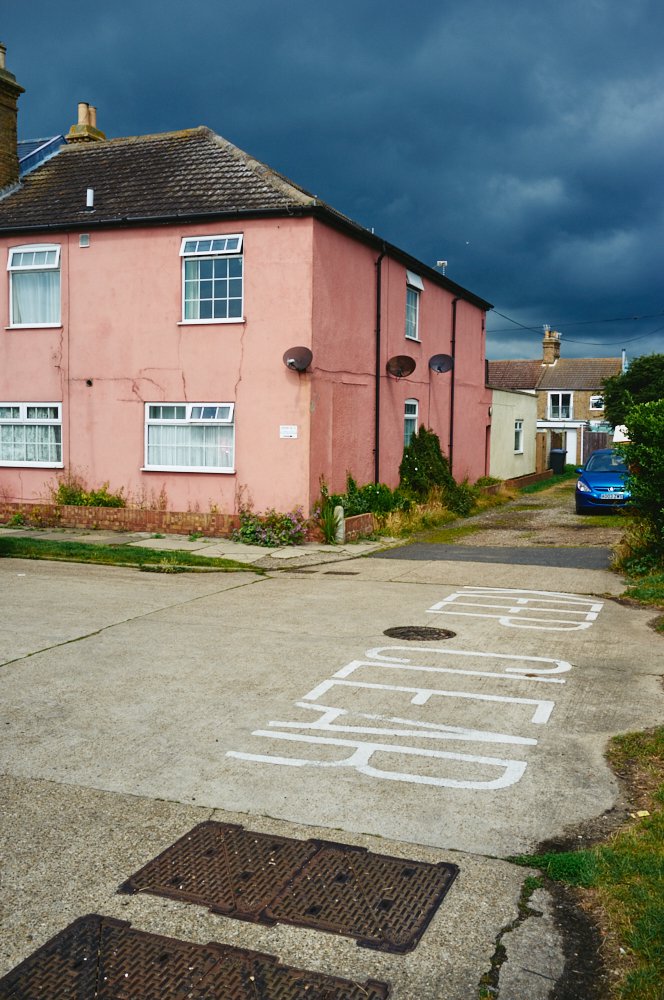 pink house against a dark sky