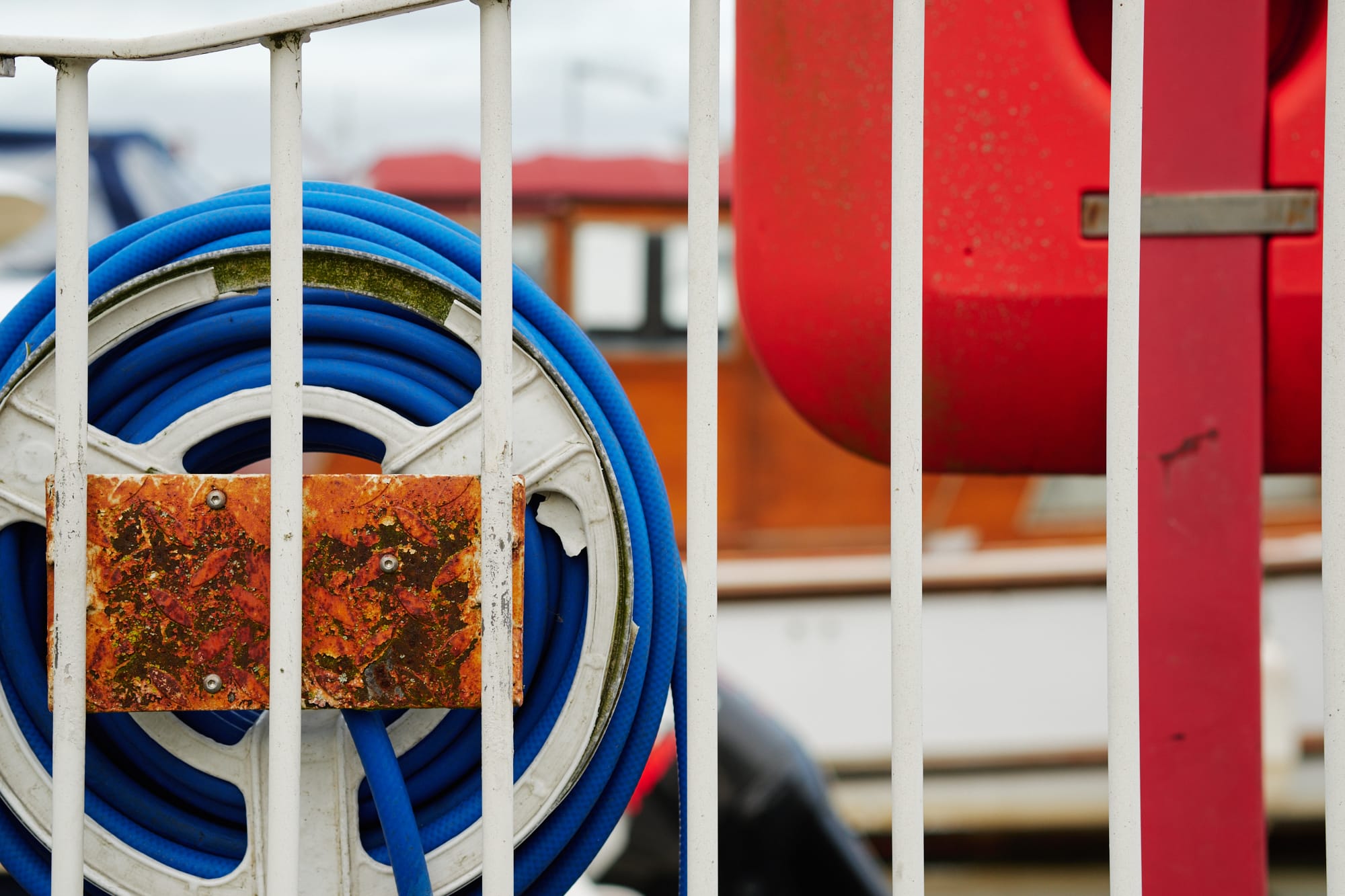 blue hose reel and rusty metal plate