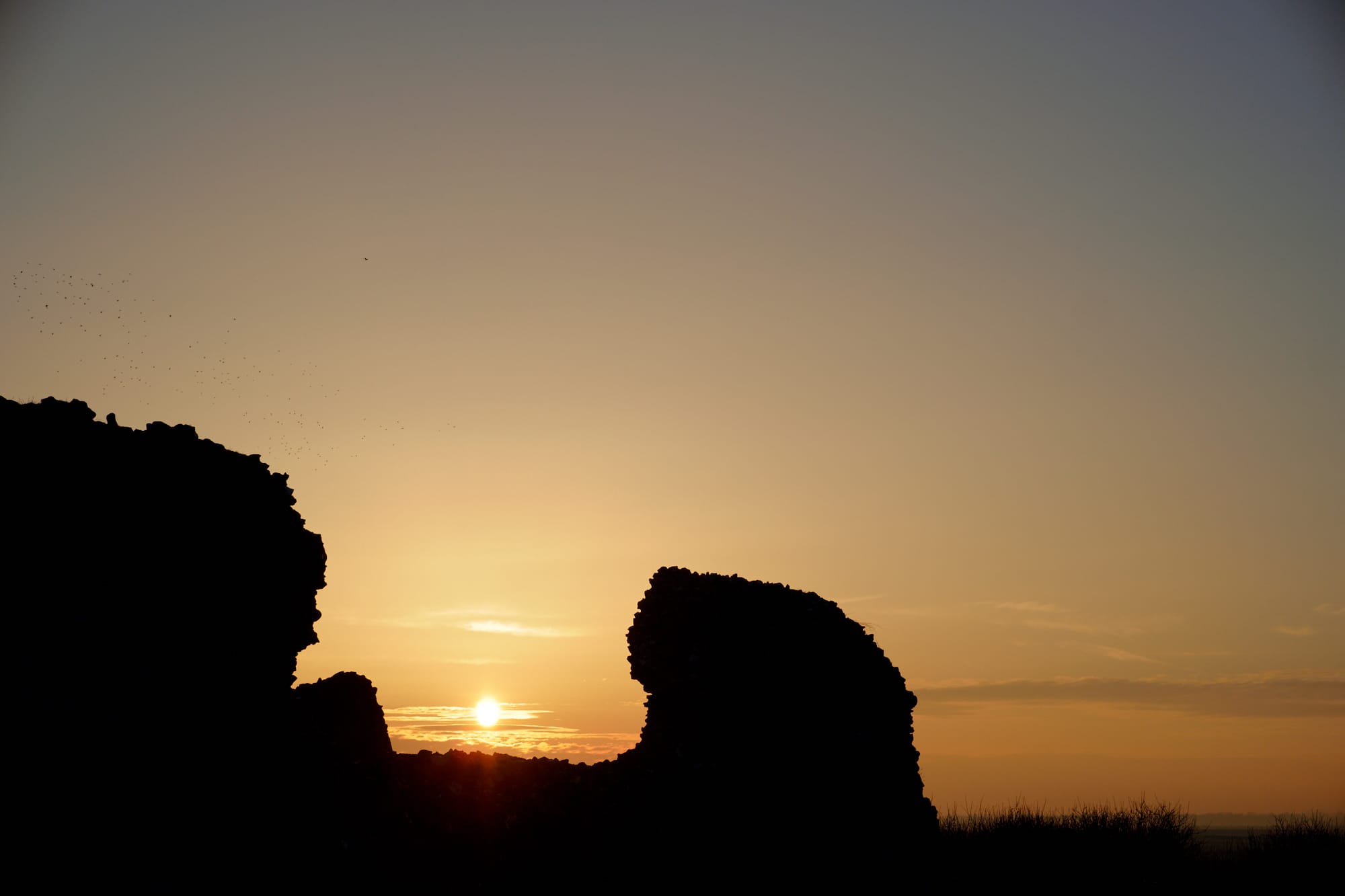 setting sun between two sections of fort wall