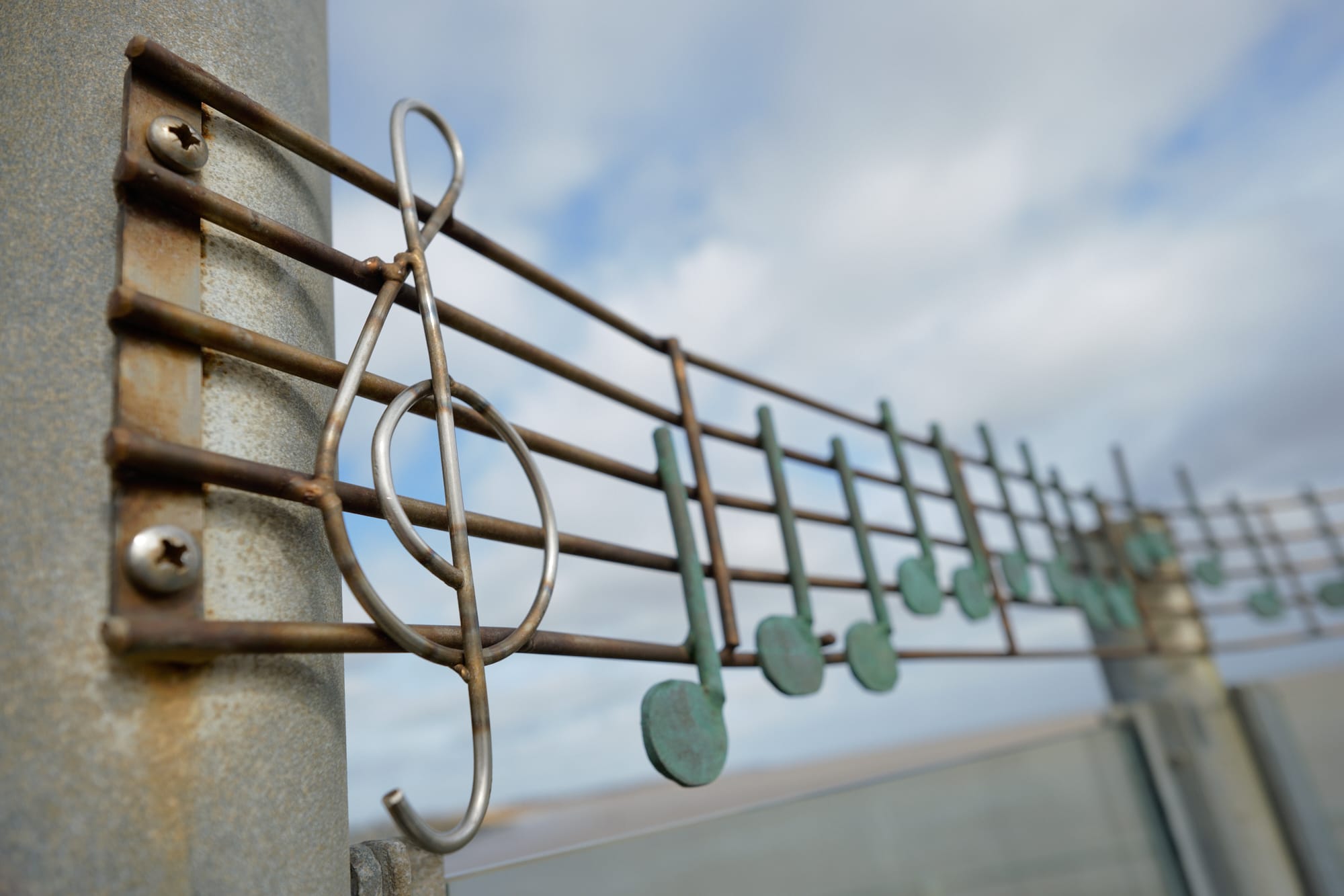 metal musical notes above outdoor seating