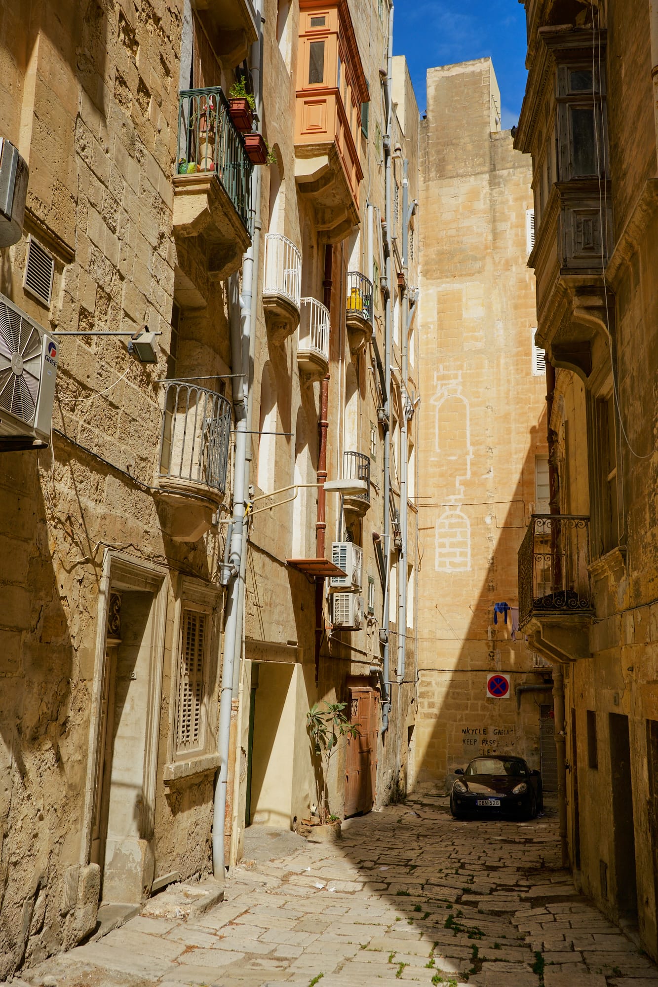 car parked at the end of an alleyway