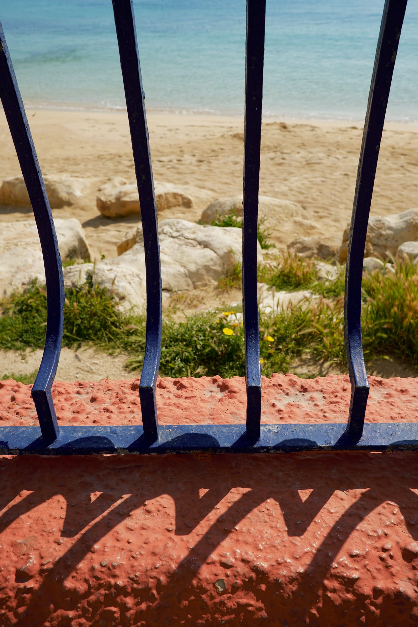 blue railings on a red wall