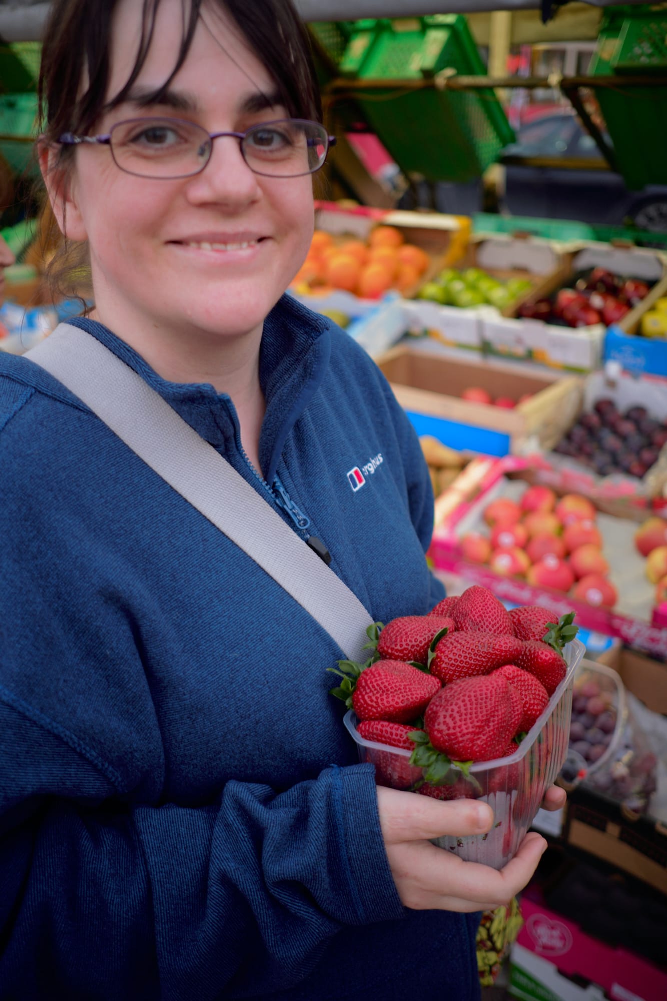 Zoe with a box of huge strawberries