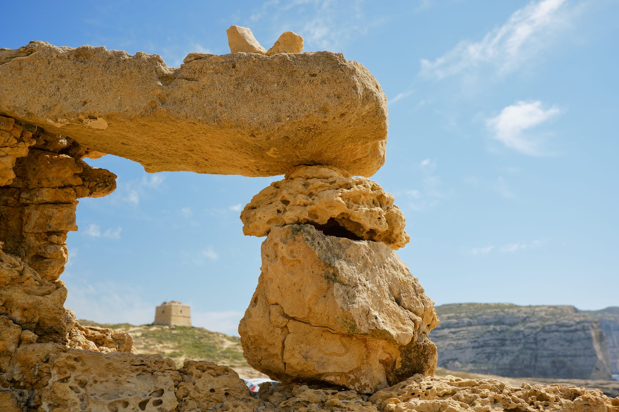 view of watchtower through a small pile of rocks