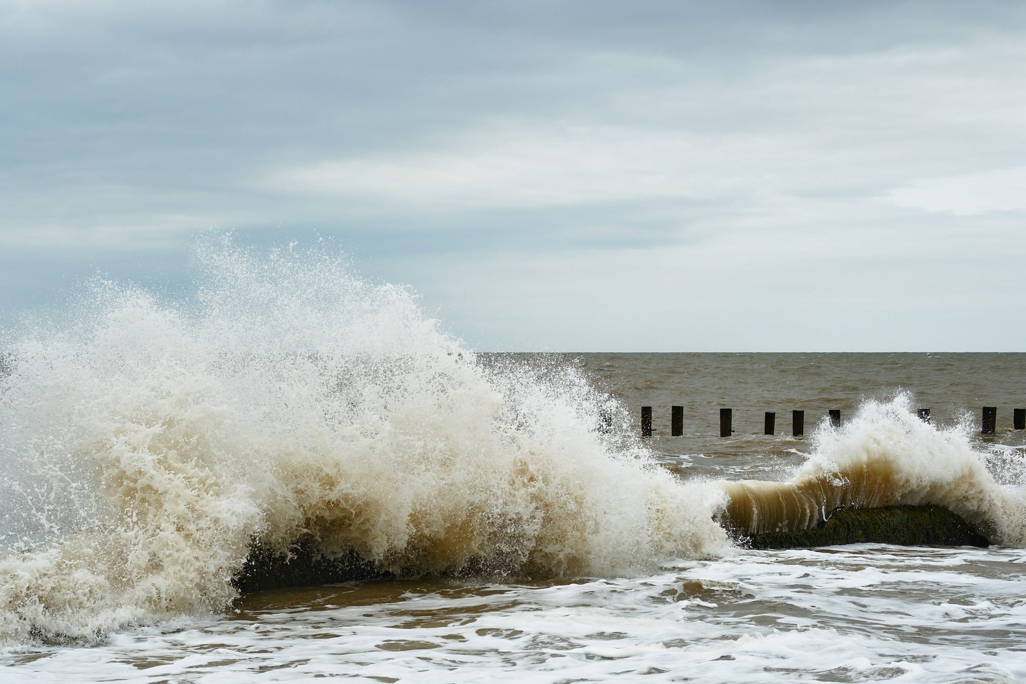 waves crashing over chunks of concrete