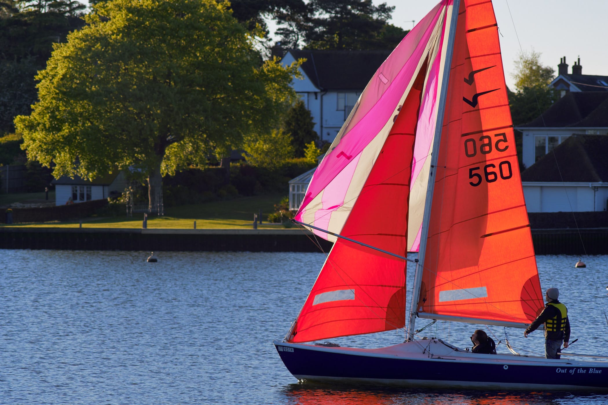 red-sailed dinghy