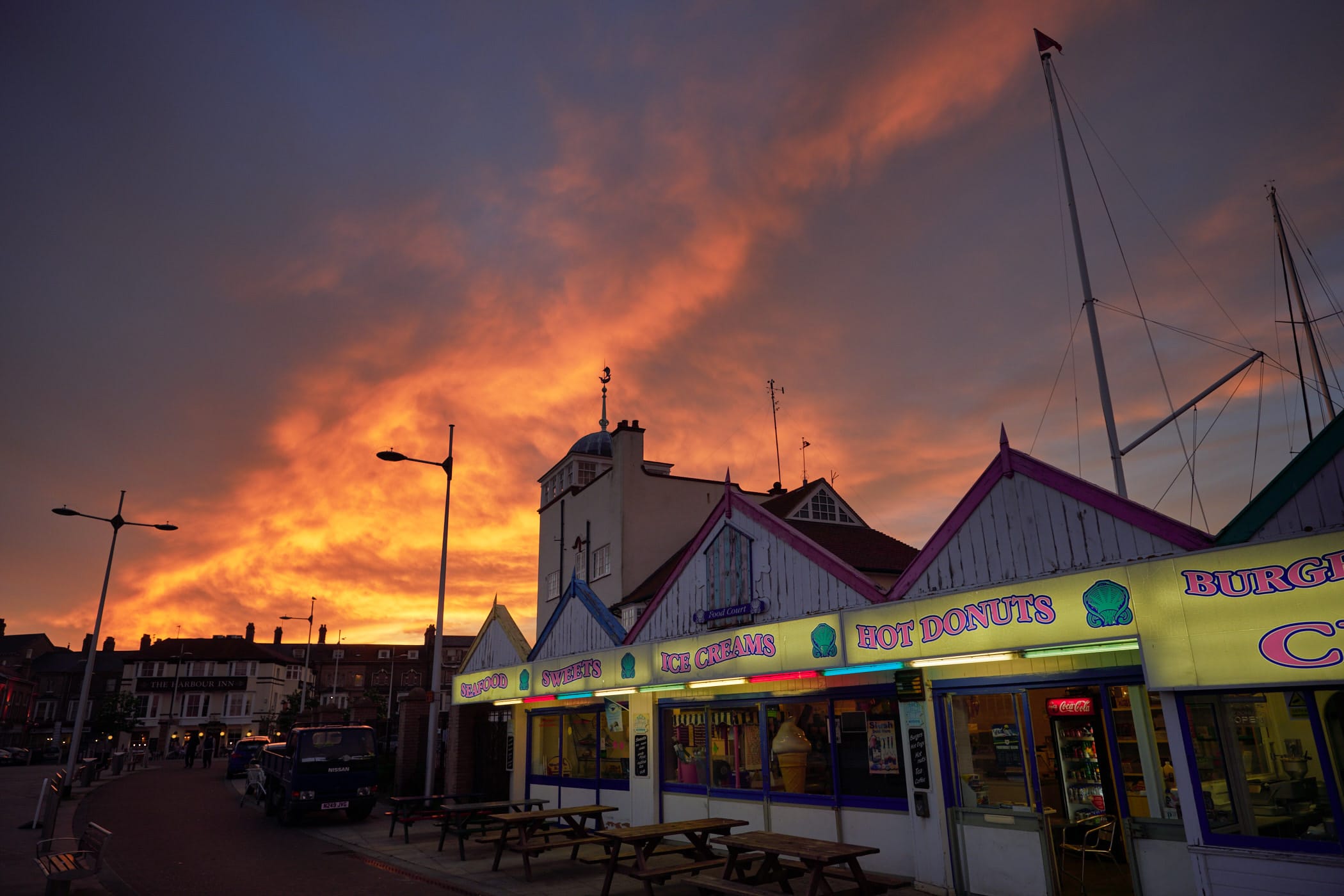 sunset sky and lit up shop fronts