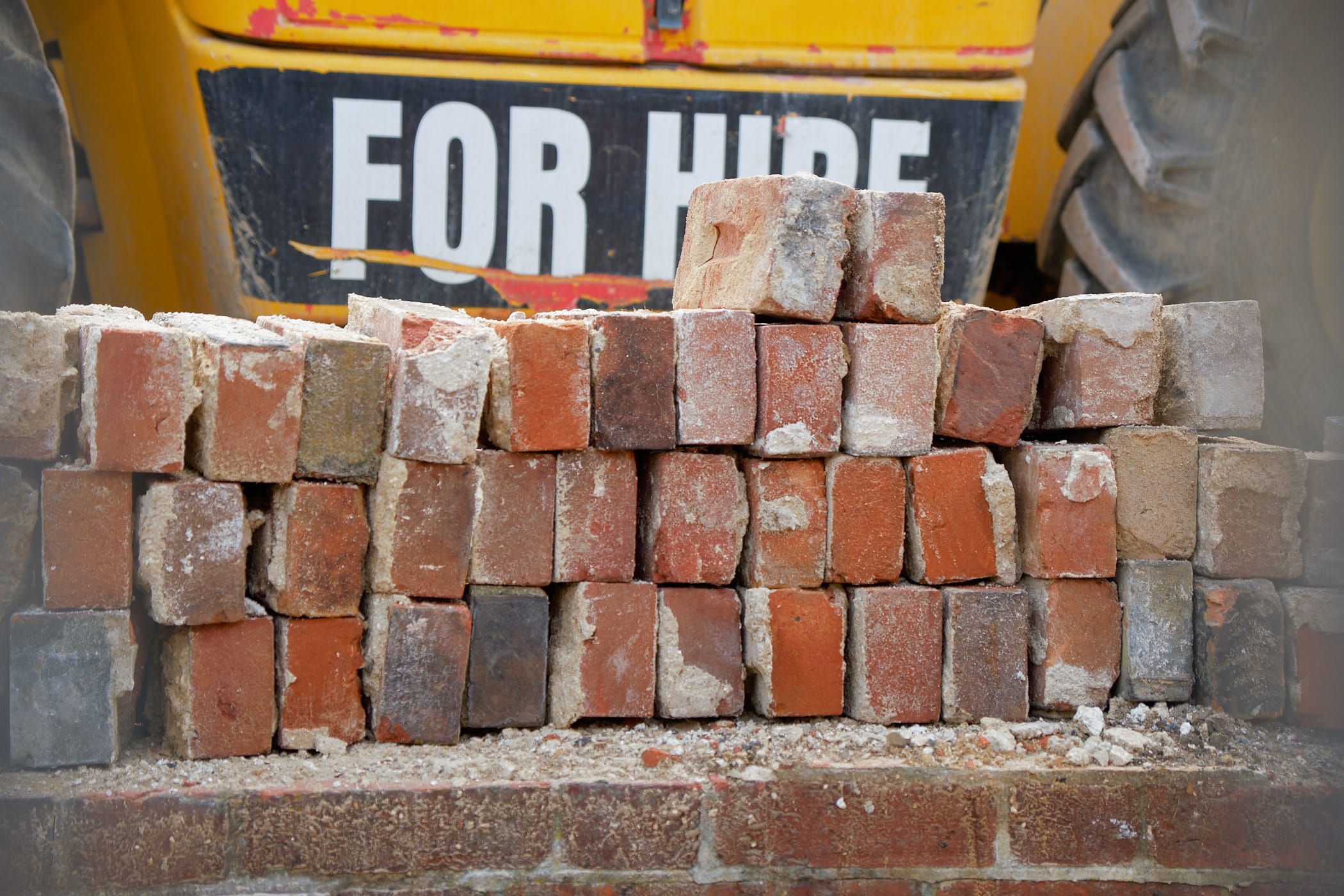 bricks in front of digger