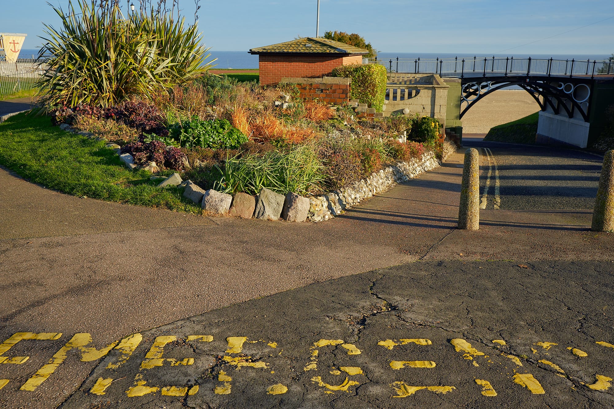 EMERGENCY lettering on road leading down to the beach