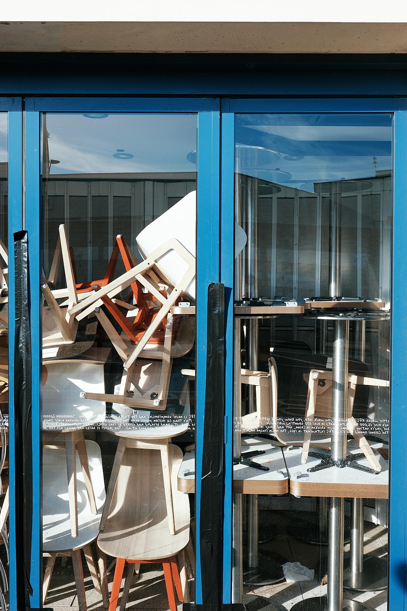 chairs stacked against shop window