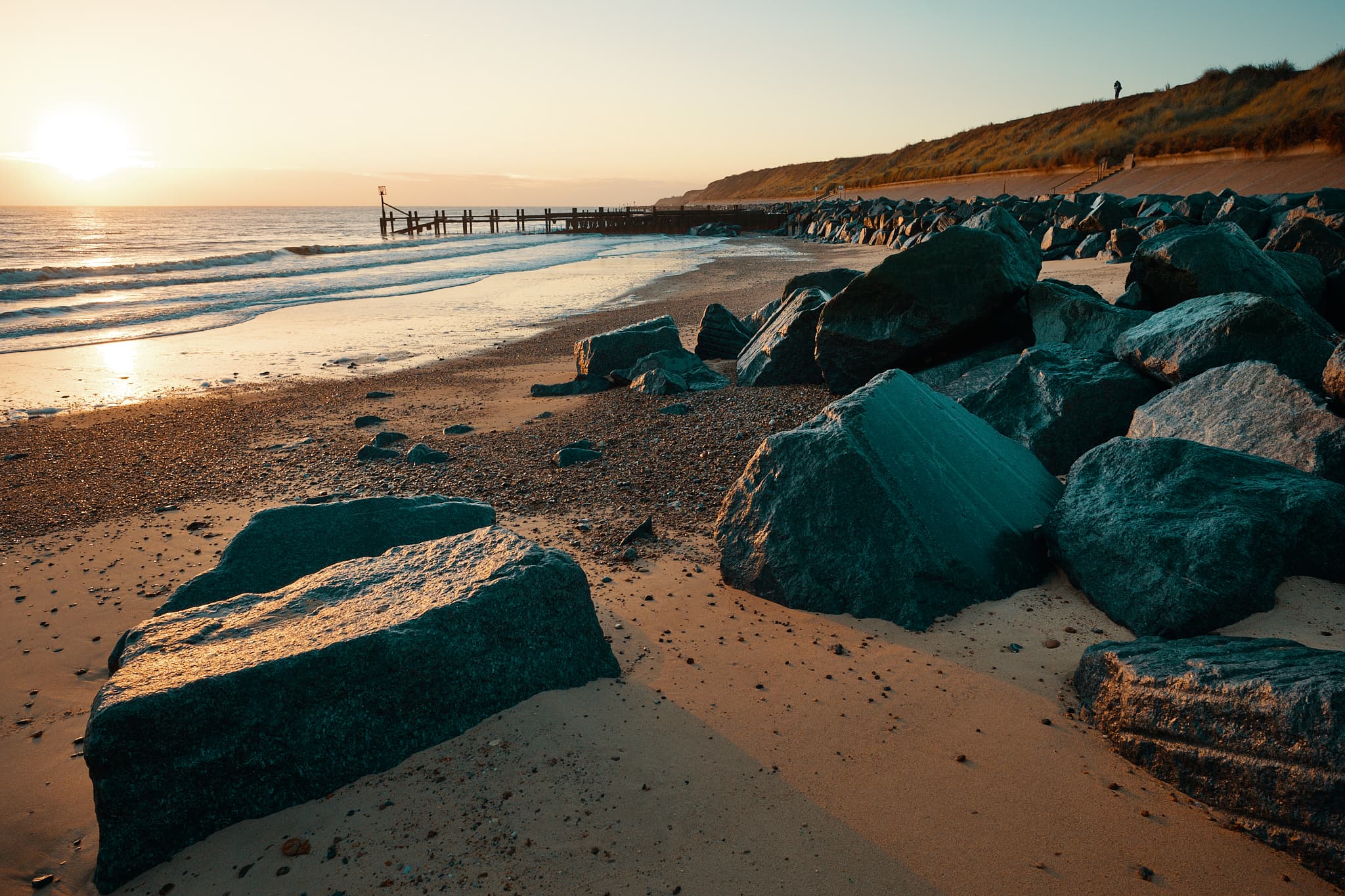 rocks on Hopton beach at dawn