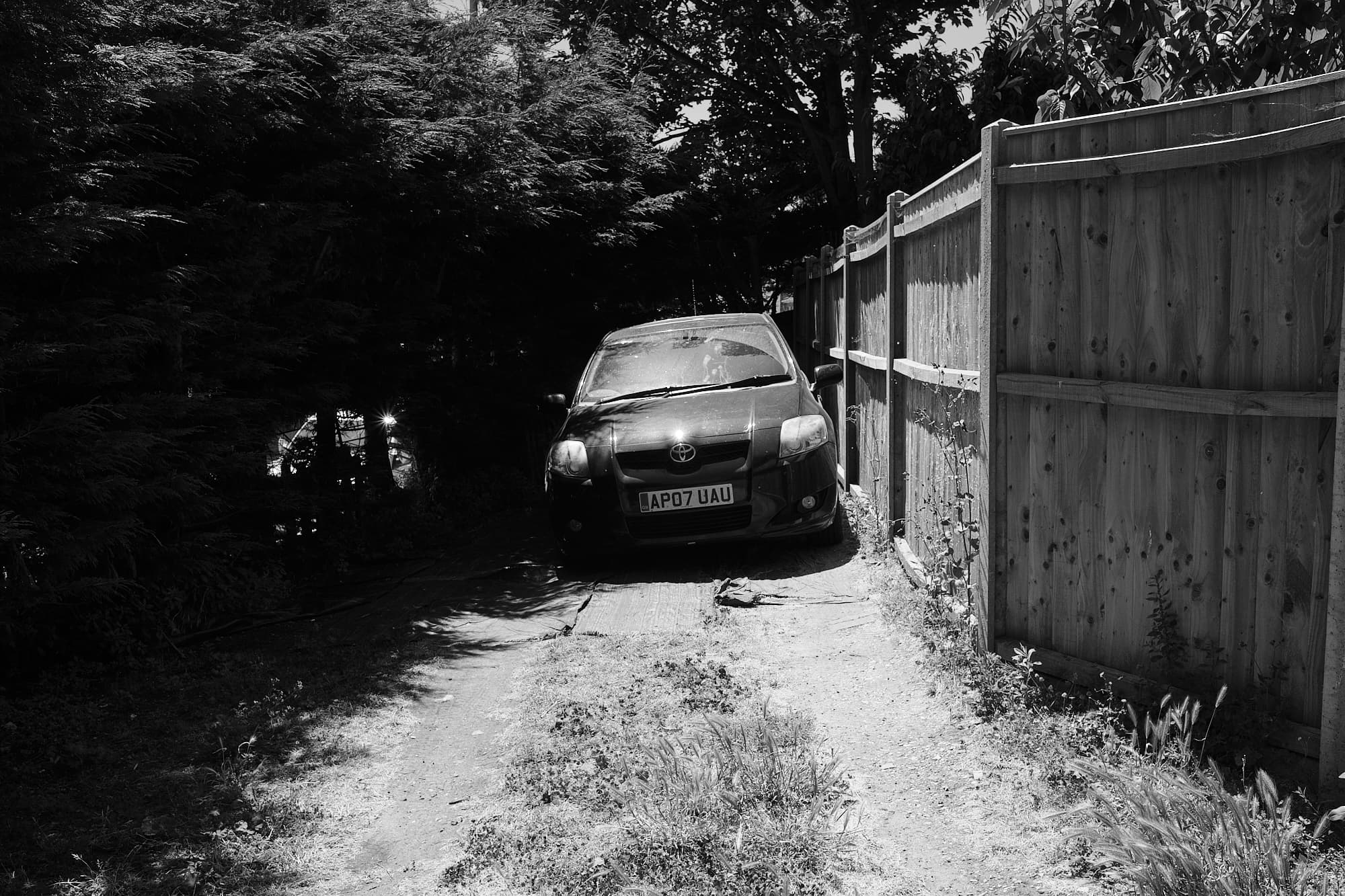 car parked by a wooden fence