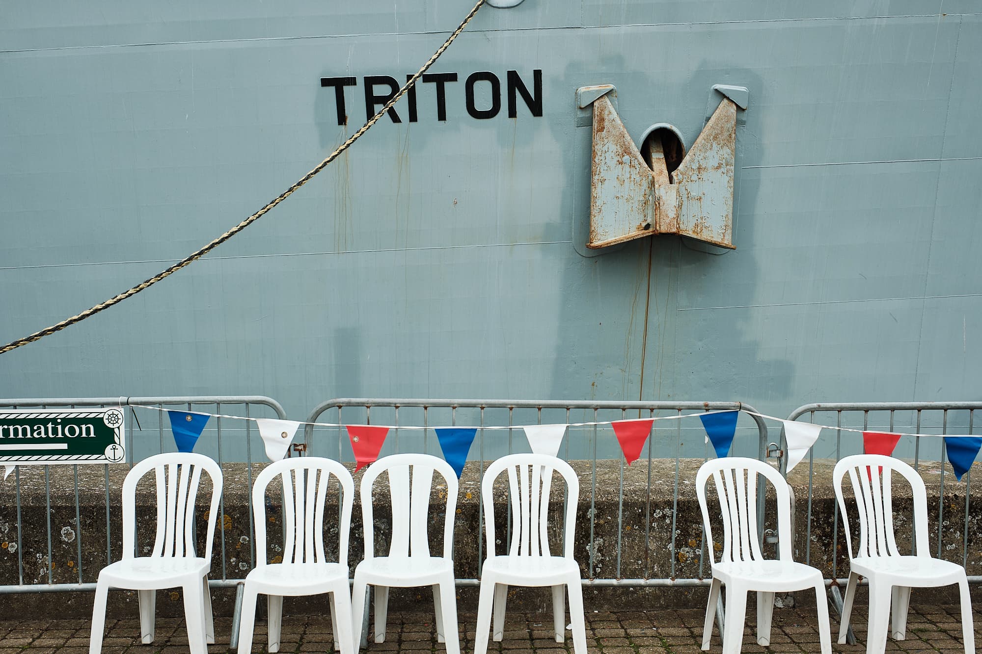 chairs along the sea wall next to RV Triton