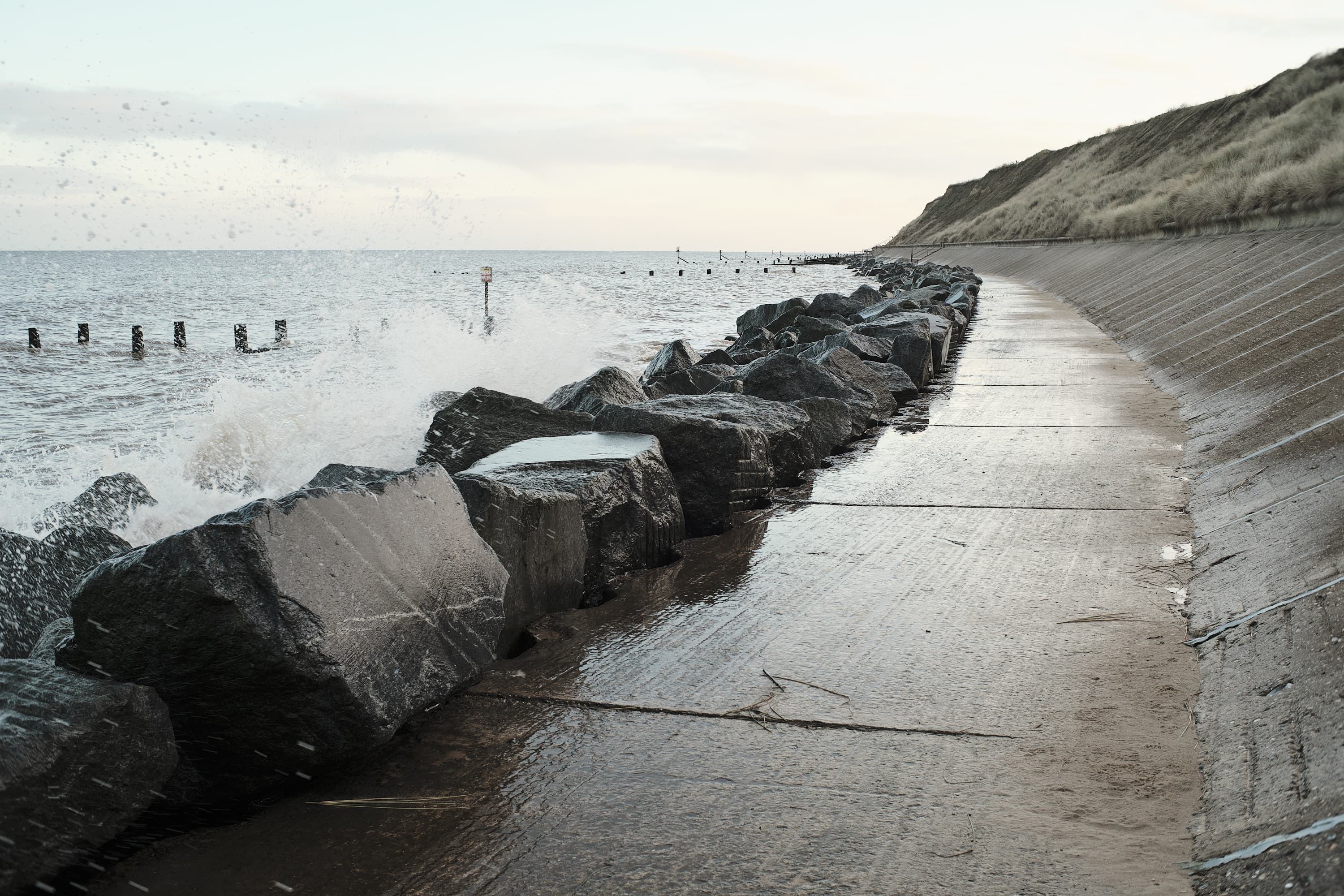 wave crashing over shoreline preservation rocks on Hopton beach