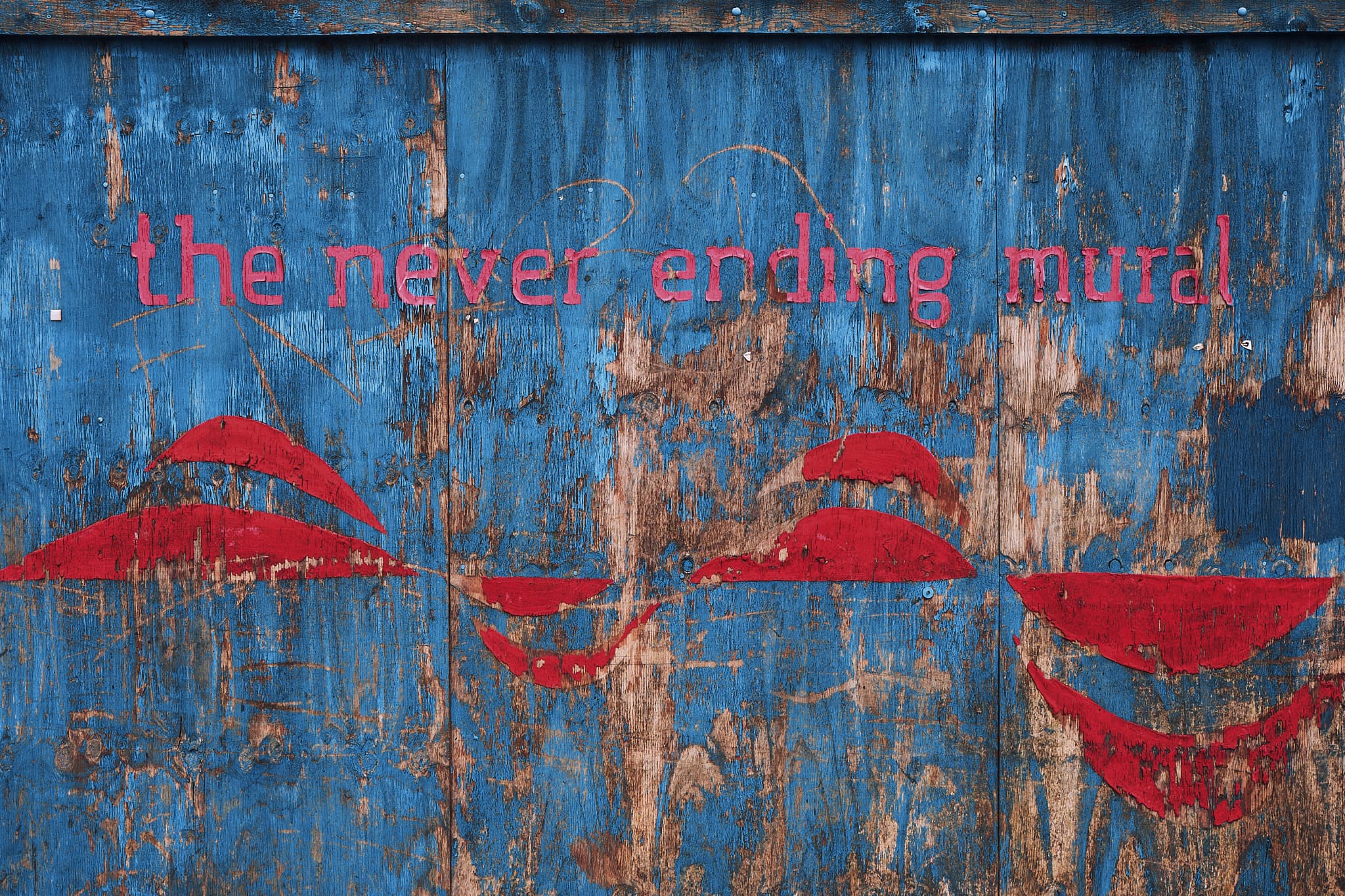 red ‘mural’ on a blue fence