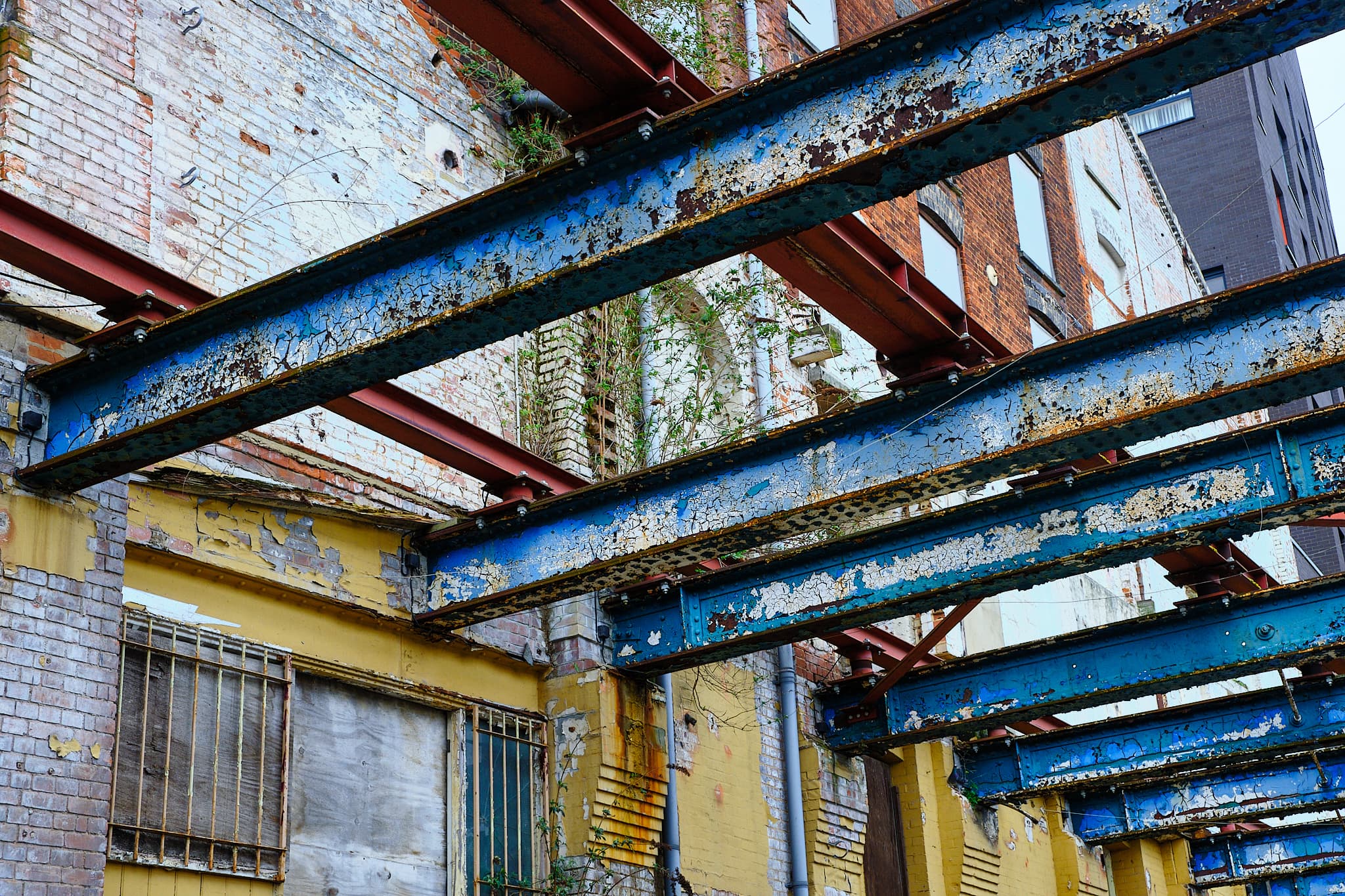 blue girders on a yellow wall