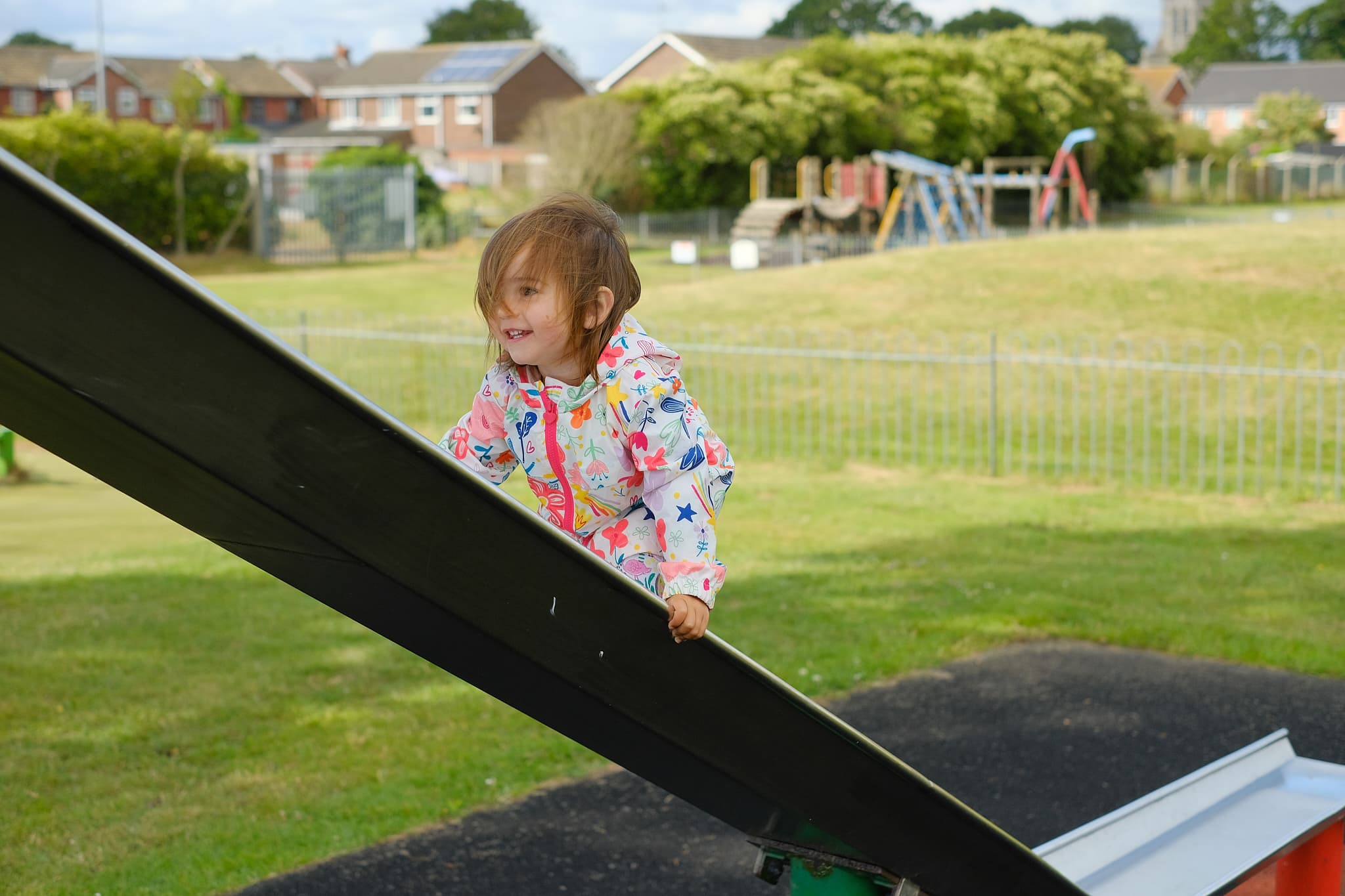 Emily climbing up a slide