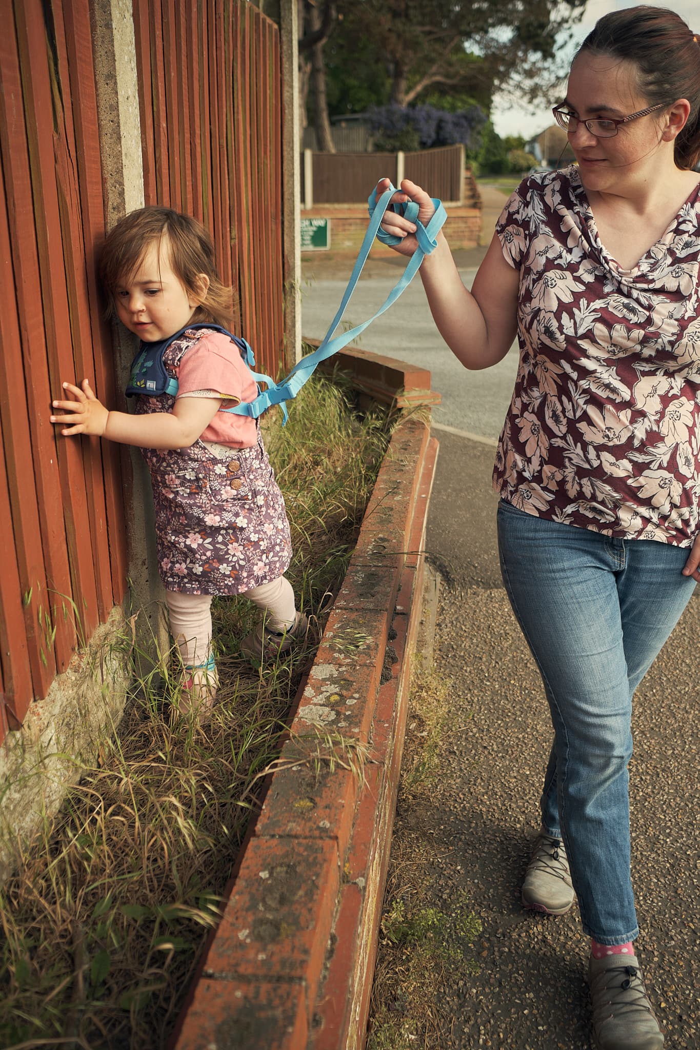 Zoe assisting Emily walking along a wall