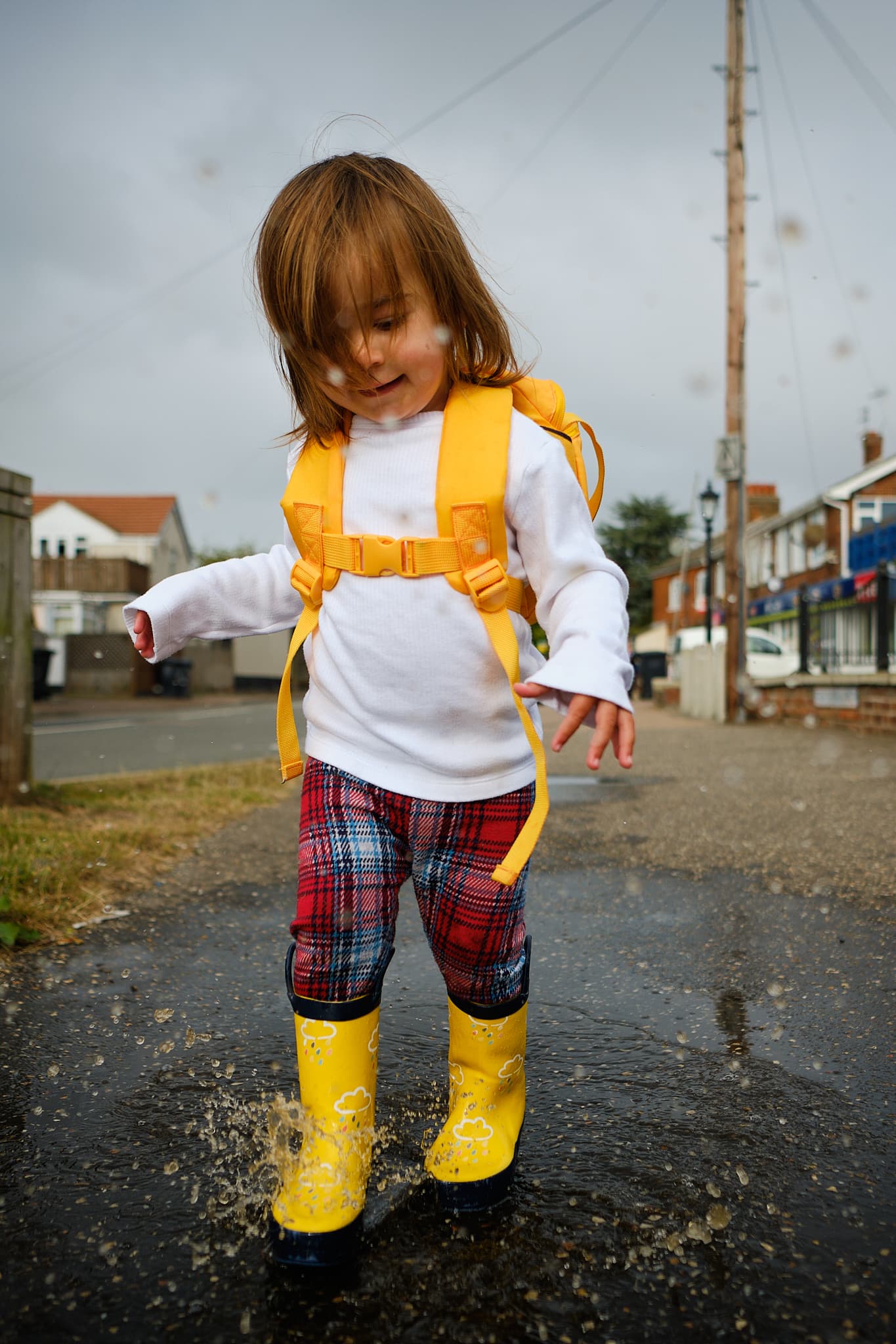 Emily splashing in a puddle