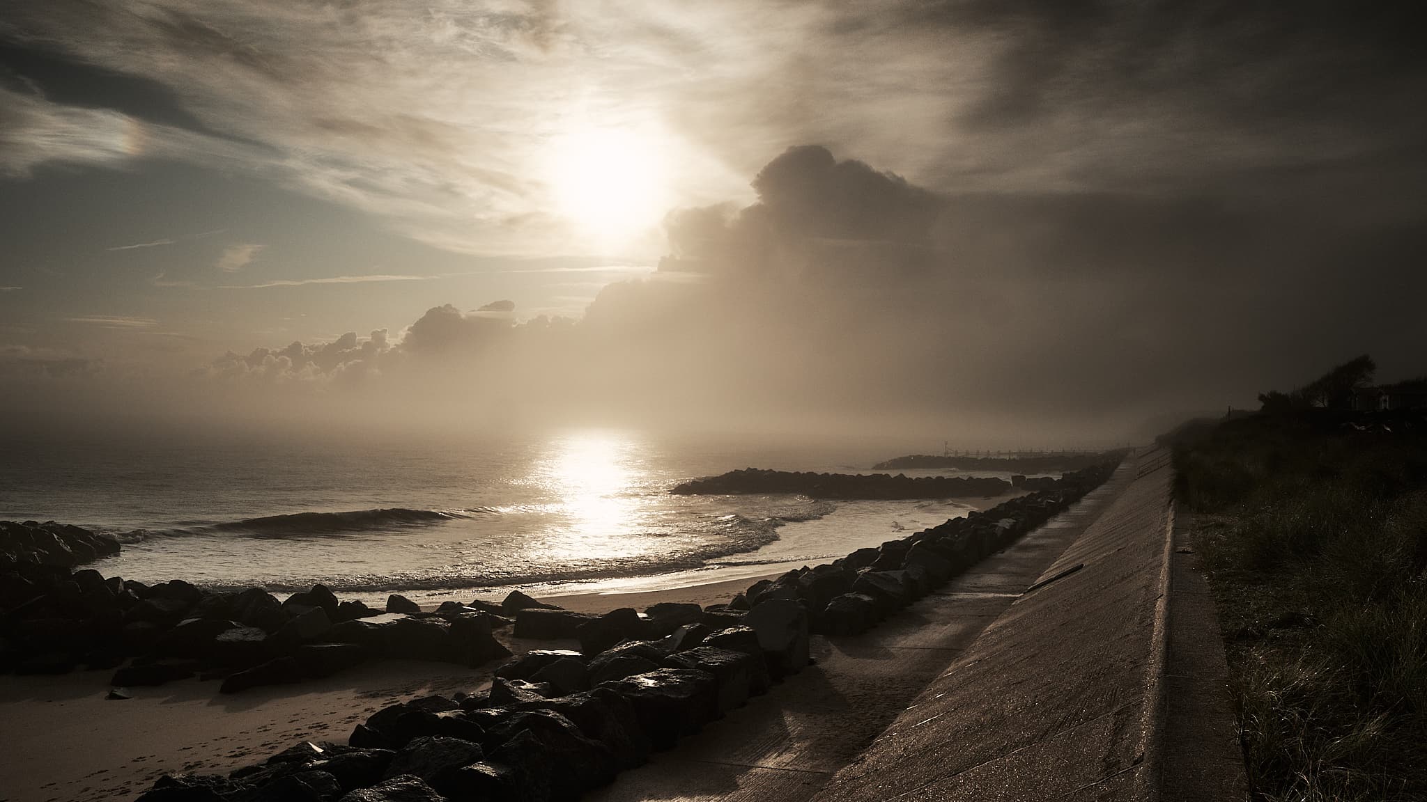 low sun over a foggy beach