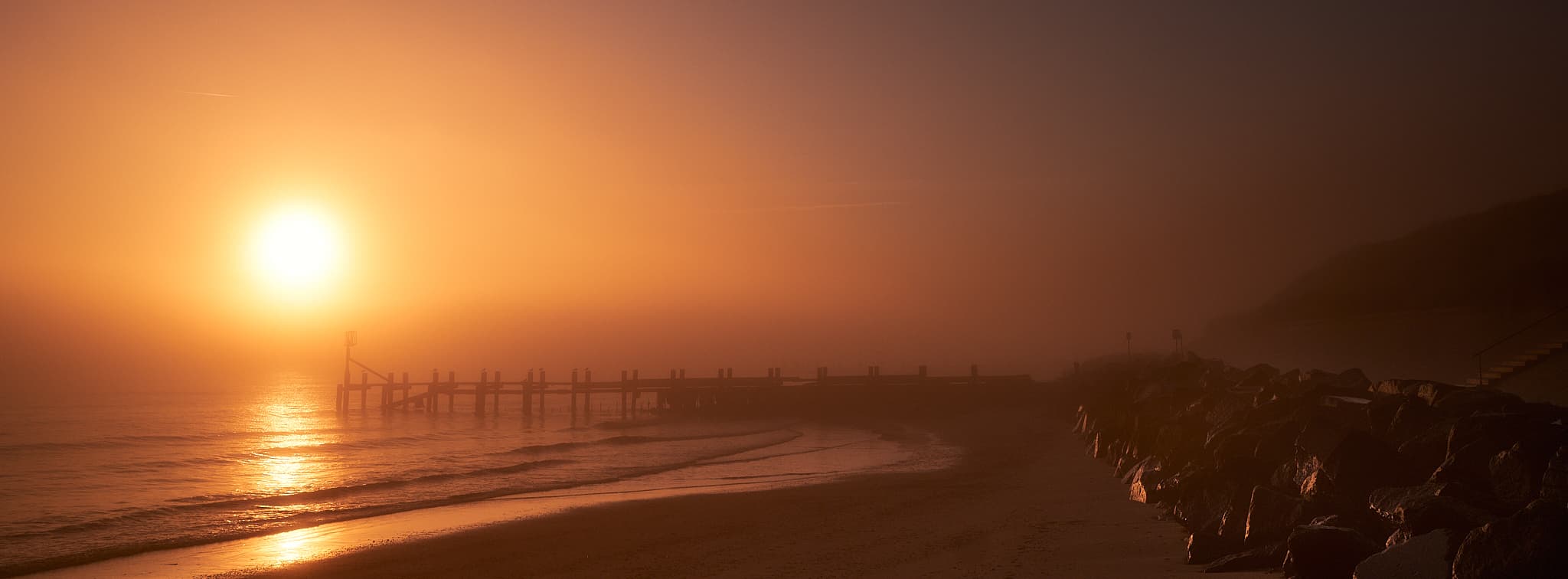 beach sunrise on a foggy morning