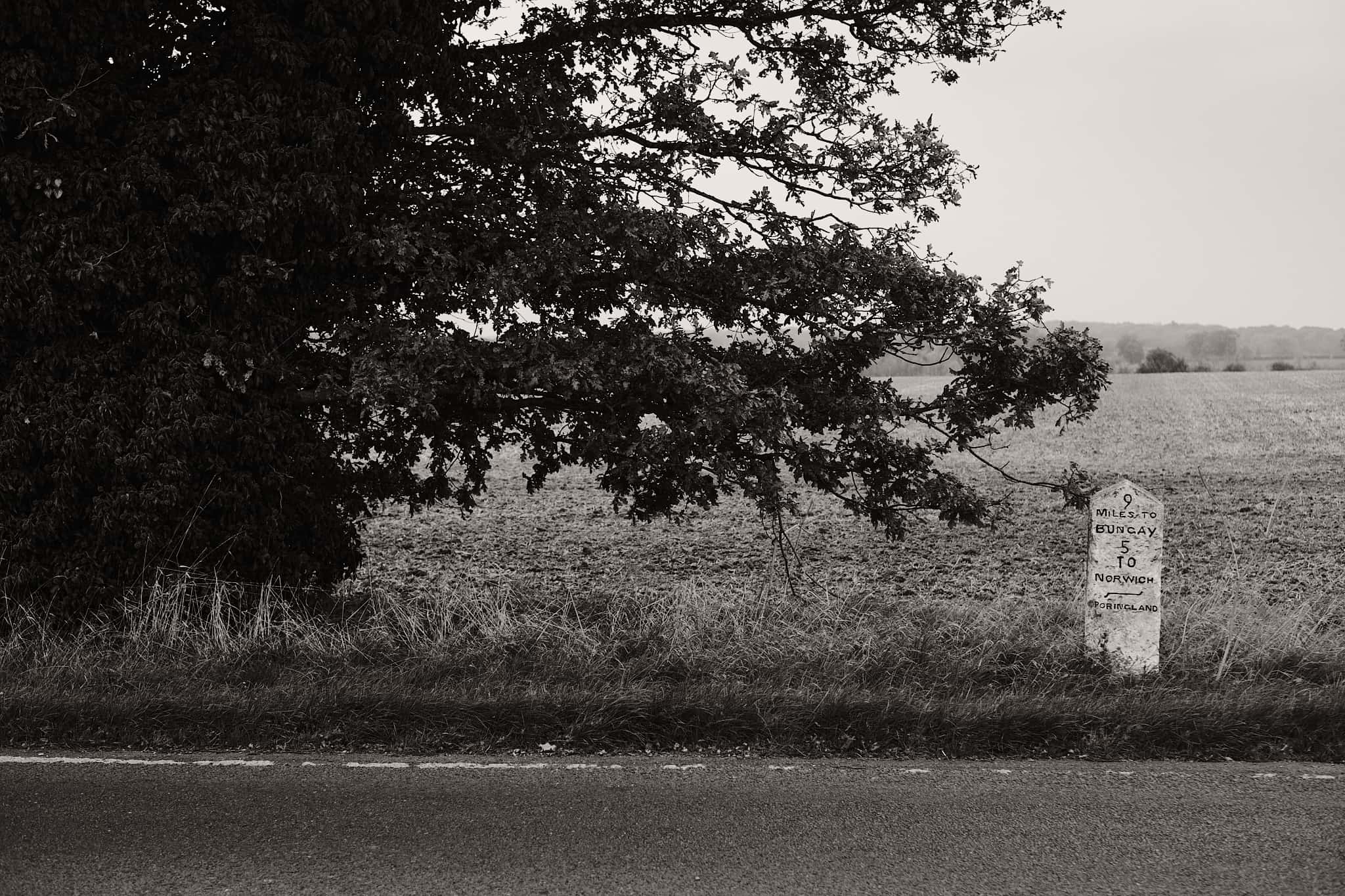 old milestone showing 9 miles to Bungay and 10 miles to Norwich